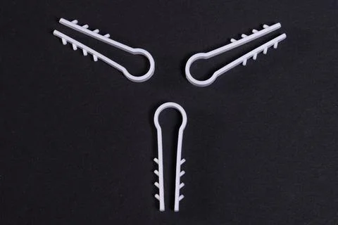 Clamps for fixing the cable in the ceiling in the form of three beams Stock Photos