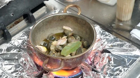 Clams with garlic in copper pot  Stock Footage 95289067