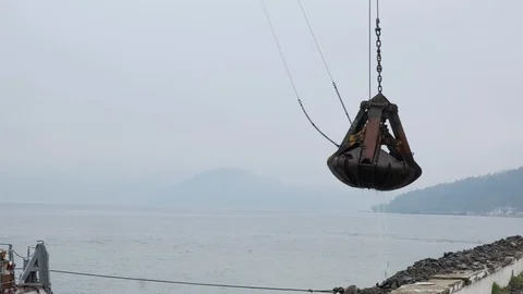 A clamshell crane on a floating platform works Stock-Footage 114307712