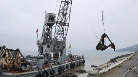 A clamshell crane on a floating platform works Stock Footage 114308132