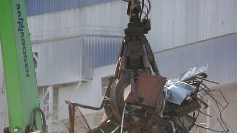 Clamshells loading the scrap metal on a truck, close-up Stock Footage 71590065