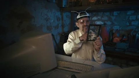 Clandestine laboratory Nutty Professor. Funny  vlogger sitting by the computer. 動画素材 154093976