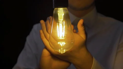Clap and burning yellow light bulb. Stock Footage 223828803