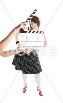 A clapper board being held up in front of a young actress Stock Photos