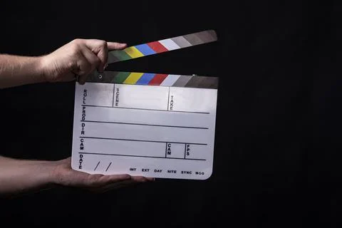 Clapperboard Being Held on Black Background Stock Photos