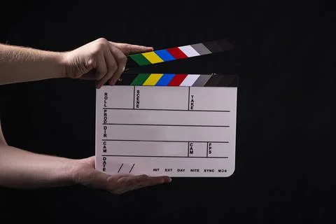 Clapperboard Being Held on Black Background Stock Photos