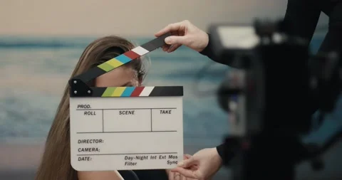 Clapperboard hit on film set in studio by directress with an actress Stock Footage 155302924