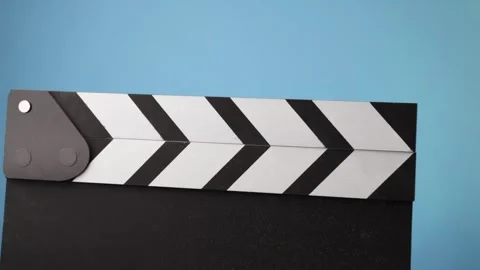 Clapperboard in motion, filmmaking scene, chalk dust flying as the board clap Stock Footage 308703447