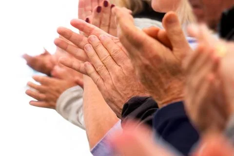 Clapping hands of a group of people in a row on white background Fotos Stock