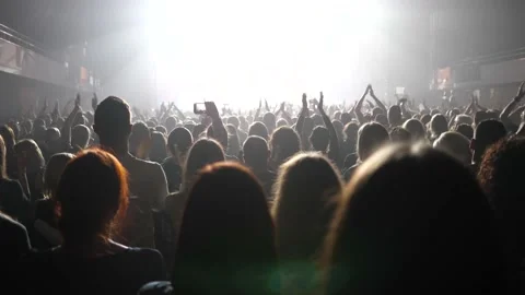 Clapping spectators - cheering concert crowd fan people in stage bright light lu Stock Footage 149271635