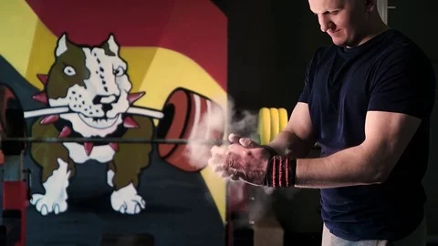 Clapping white chalk powder into a cloud against dark background Stock Footage 76315386