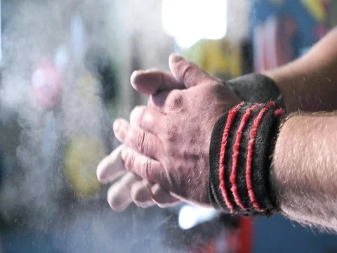 Clapping white chalk powder into a cloud against dark background Stock Footage 77517757