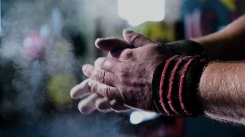 Clapping white chalk powder into a cloud against dark background Stock Footage 77764860