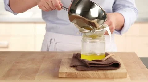 Clarified butter being sieved Stock Footage 24671461