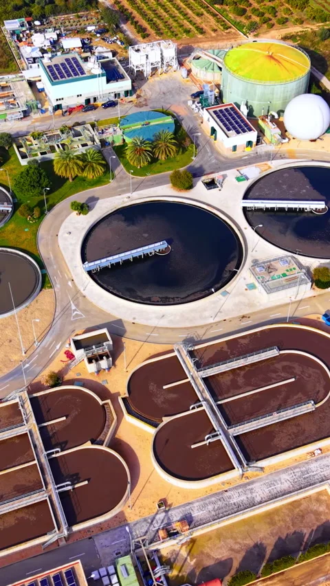 Clarifier tanks, digester and solar roofs at wastewater plant, Spain Vertical Stock Footage 346841761