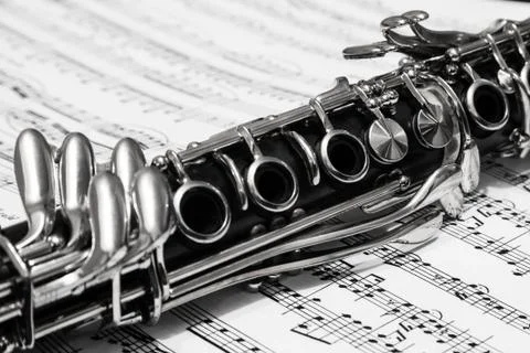 Clarinet over the page with notes Stock Photos