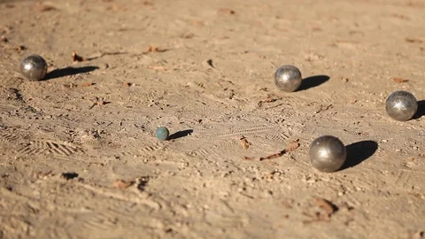 Clashes of metal balls during a game of petanque outdoors. Petanque player Видео 110764964
