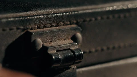 The clasp of a black briefcase that snaps open macro shot Stock Footage 336236014
