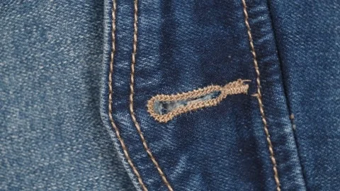 Clasp loop on pocket blue jeans. rotation fabric of jeans with closeup details. Stock Footage 240464407