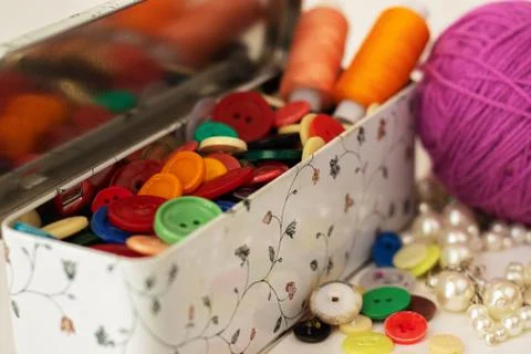 Clasp for loops, for clothes. Multicolored in a box and scattered. Stock Photos