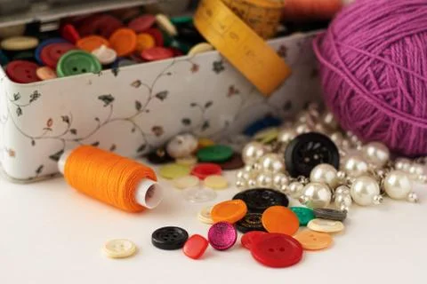 Clasp for loops, for clothes. Multicolored in a box and scattered. Stock Photos