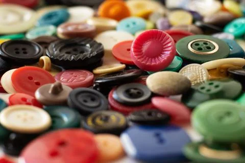 Clasp for loops, for clothes. Multicolored in a box and scattered. Stock Photos