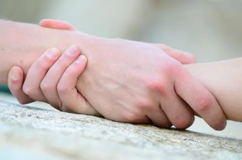 Clasped hand for help Stock Photos
