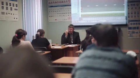 Class driving school, road signs, teacher man wearing glasses lectures a class Stock Footage 73431361