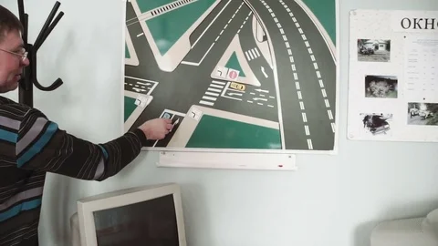 Class driving school, road signs, teacher man wearing glasses lectures a class Stock Footage 73520783