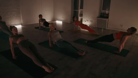 Class Engaged in Reverse Plank Pose Stock Footage 267757108