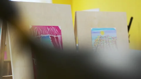 Class of fine arts contains easels with attached children drawings Stock Footage 295271905