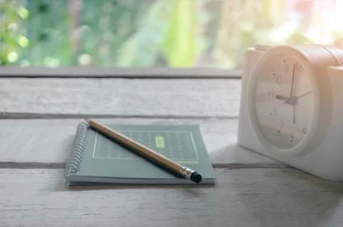 Class room in nature background with Green books pencils alarm clock on a whi Stock Photos