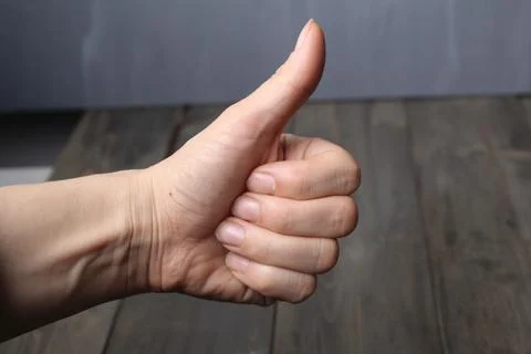 Class sign with a hand on a gray background in close-up. Hand approval. Com.. Stock Photos