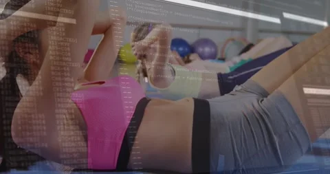Class start lead woman doing crunches, others mirroring, building core, code Stock Footage 330936105