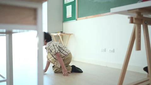 In class, The teacher and students sing together, and the boys dance happily Stock Footage 282878586