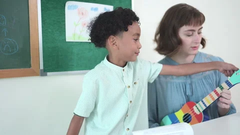 In class, The teacher and students sing together Stock Footage 283057920
