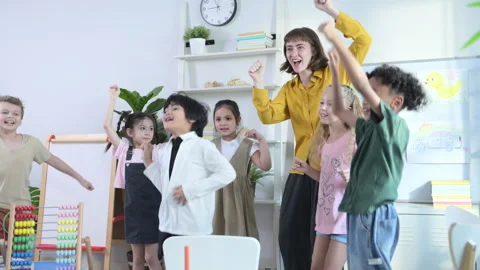 In class, The teacher and students sing and dance together Stock Footage 285326932