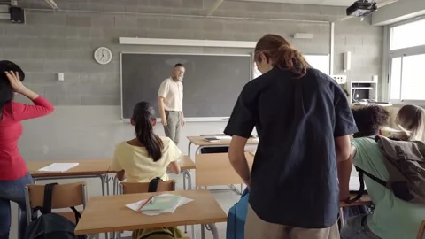 Classes start in the morning. The young high school students enter the classroom Stock Footage 165193151