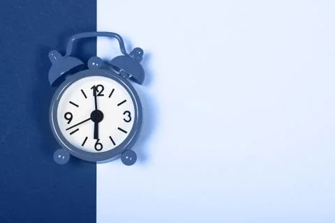 Classic alarm clock on double background. Stock Photos
