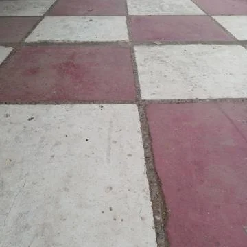 Classic alternating checkerboard pattern outdoor courtyard floor tiles Stock Photos