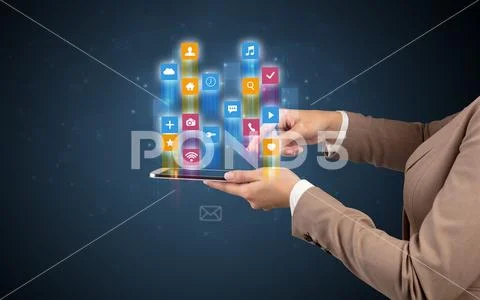 Classic application icons coming out from tablet Stock Photos