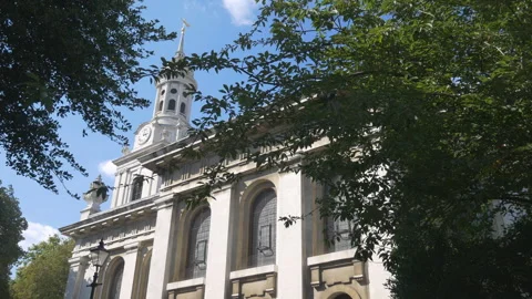 A classic architectural building with a clock tower, surrounded by trees. Stock Footage 287503667