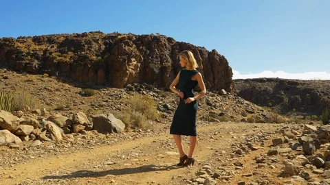 Classic Beautiful Lady Posing Rocks and Dry Land in Background Video stock 114174184