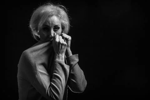 Classic black-and-white dramatic portrait of elderly blonde woman in Studio o Stock Photos