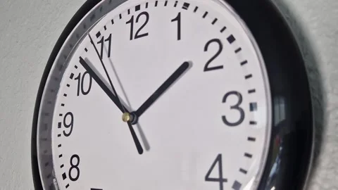 Classic Black Wall Clock on a White Wall – Close up 库存影片 344285336