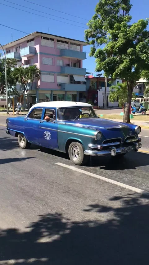 Classic blue Dodge car driving on sunny street in Varadero Cuba vertical 库存影片 344464441