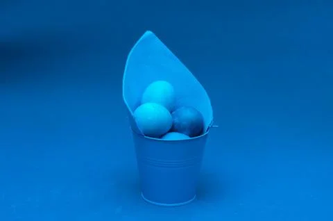Classic blue easter eggs in bucket in the center of the frame Stock Photos