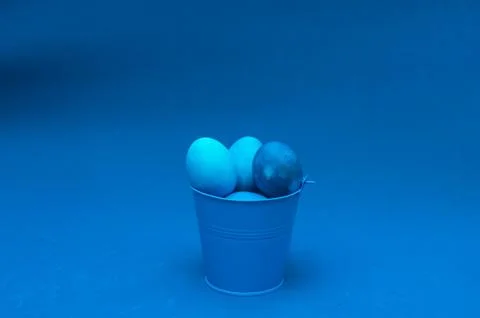 Classic blue easter eggs in bucket in the center of the frame Stock Photos
