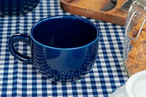 Classic blue empty ceramic tea cup on kitchen table Stock Photos