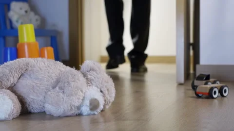 A classic brown teddy bear abandoned off the floor at night in a child's bedr Vidéo 274807700